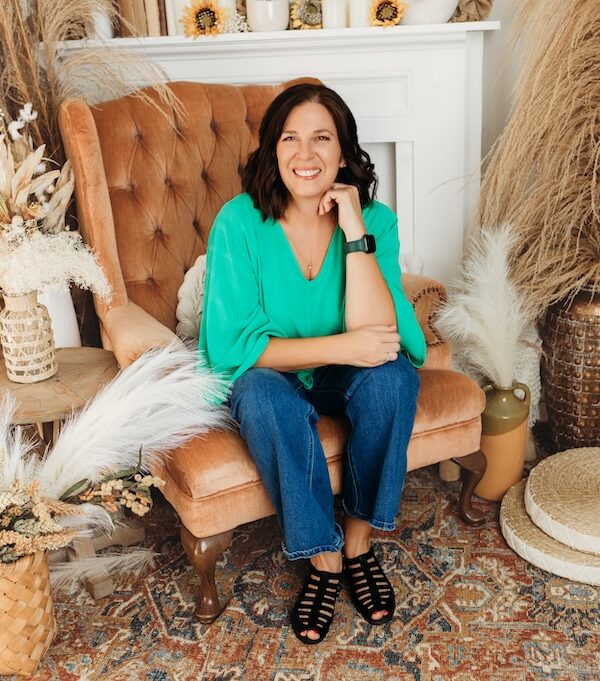 Smiling woman leaning forward in comfortable living room chair